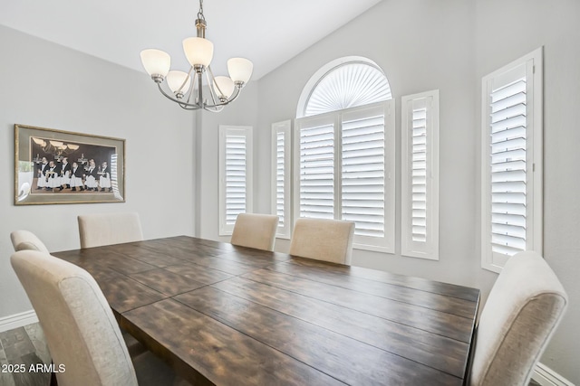 dining area with a chandelier, baseboards, and wood finished floors