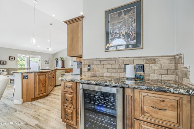kitchen featuring wine cooler, dishwasher, dark stone counters, brown cabinets, and tasteful backsplash