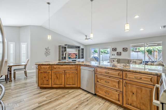kitchen with a sink, dishwasher, open floor plan, brown cabinets, and vaulted ceiling