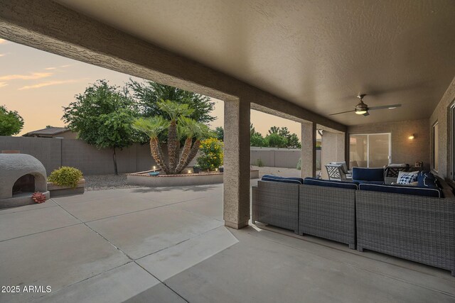 view of patio / terrace with an outdoor living space, a ceiling fan, and a fenced backyard