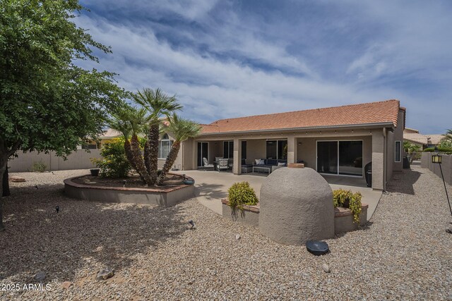 back of property featuring an outdoor hangout area, a patio area, and stucco siding