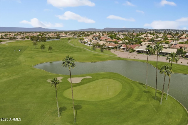 view of home's community with a residential view, a water and mountain view, and view of golf course