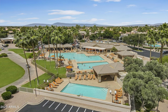 drone / aerial view of a pool area and a mountainous background
