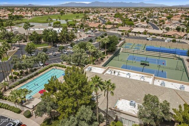 aerial perspective of suburban area with a water and mountain view and a pool