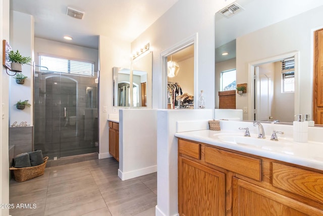 bathroom featuring visible vents, a shower stall, vanity, and tile patterned floors