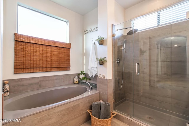 full bathroom featuring a shower stall and a bath