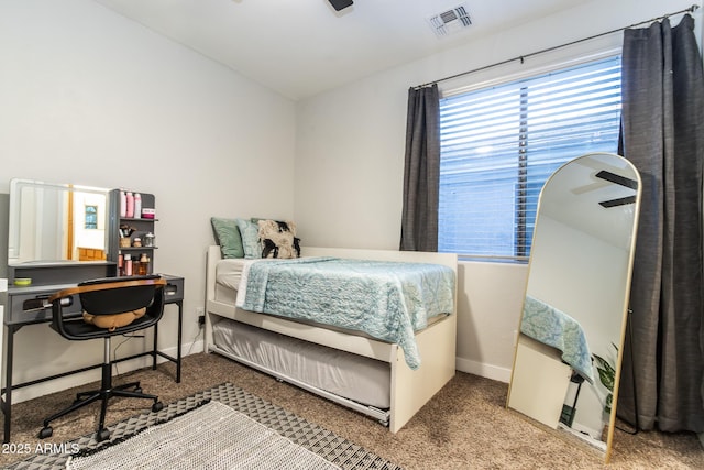 carpeted bedroom featuring visible vents and baseboards