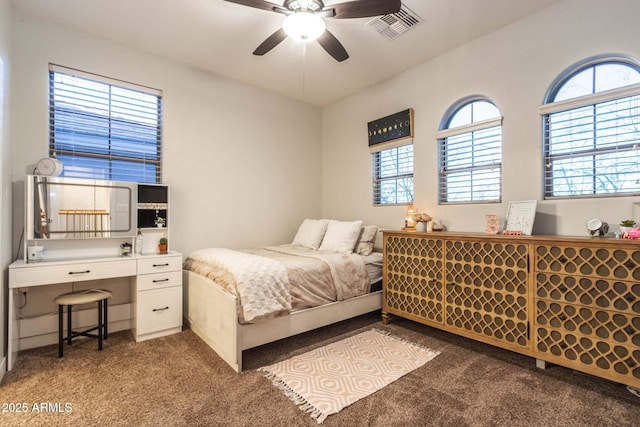 bedroom featuring a ceiling fan, visible vents, and carpet flooring