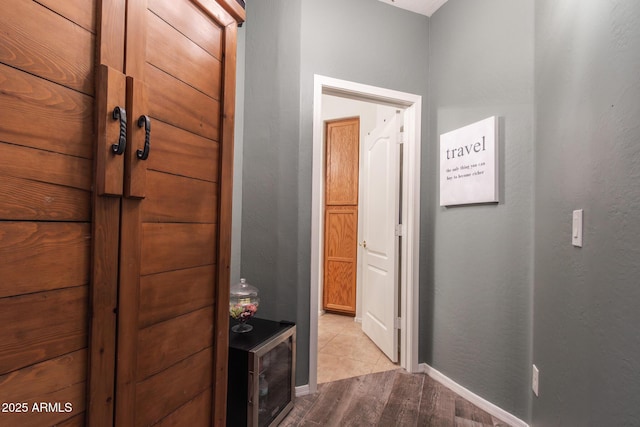 hall featuring baseboards and wood finished floors