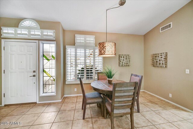 dining area with baseboards, visible vents, and tile patterned floors