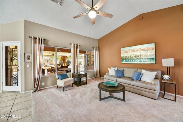 tiled living room featuring vaulted ceiling, visible vents, carpet floors, and a ceiling fan