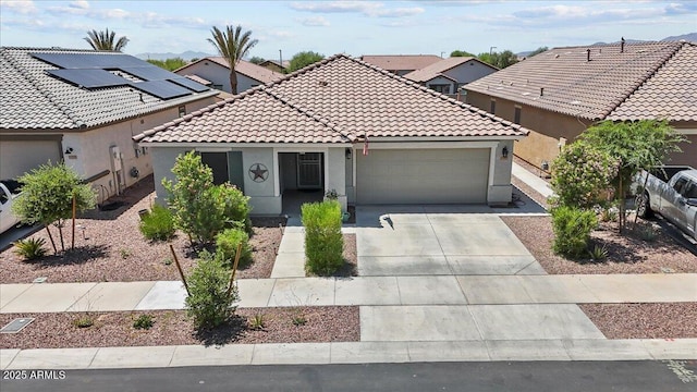 17461 W Molly Ln, Surprise, AZ 85387 - view of front facade featuring an attached garage, a tile roof, stucco siding, and driveway