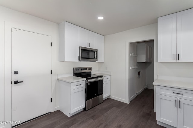 kitchen with white cabinets, dark wood-type flooring, and appliances with stainless steel finishes