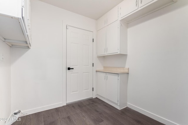 laundry area with dark hardwood / wood-style flooring