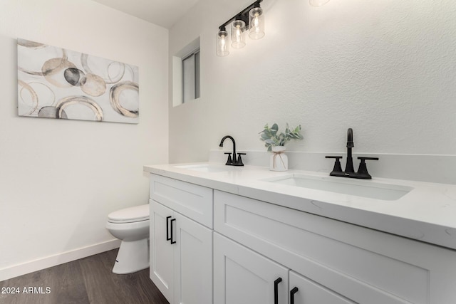 bathroom featuring hardwood / wood-style floors, vanity, and toilet