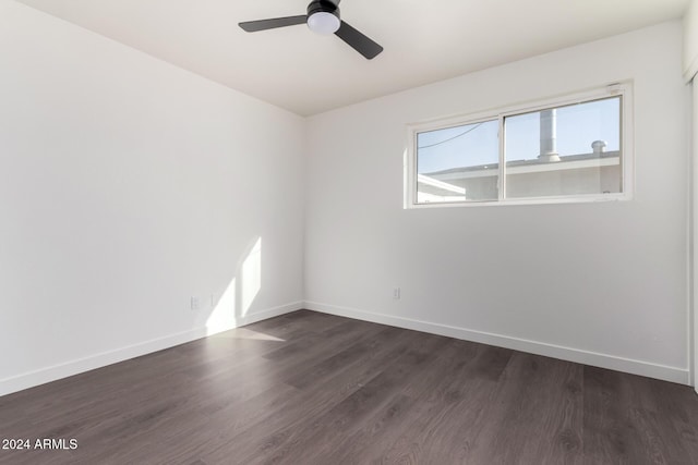 spare room with dark hardwood / wood-style flooring and ceiling fan