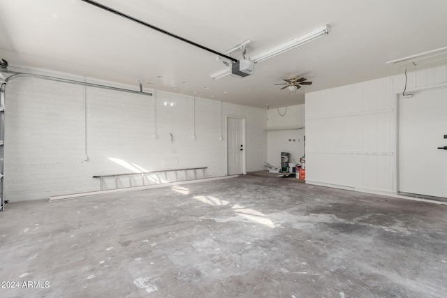 garage with ceiling fan and a garage door opener