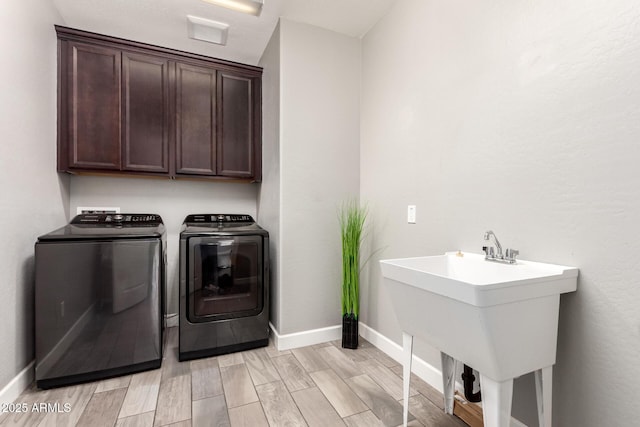 913 W Yosemite Dr, Chandler, AZ 85248 - laundry area featuring cabinet space, washer and dryer, baseboards, and light wood-style floors