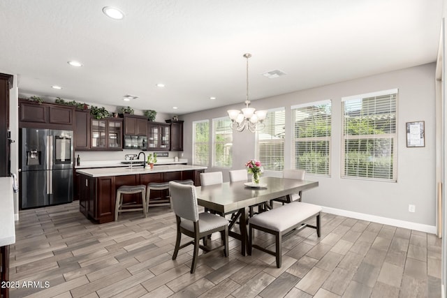 913 W Yosemite Dr, Chandler, AZ 85248 - dining space with a chandelier, wood tiled floors, recessed lighting, and baseboards