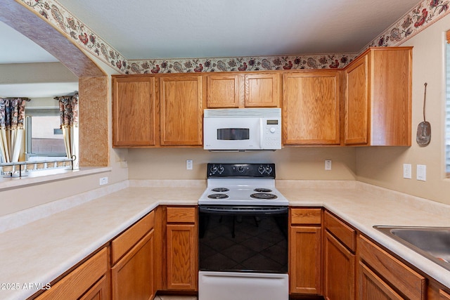 kitchen with white appliances and sink