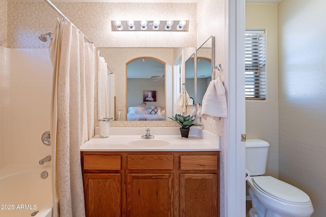 full bathroom featuring vanity, shower / tub combo, and toilet