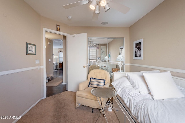 carpeted bedroom with ceiling fan and a closet