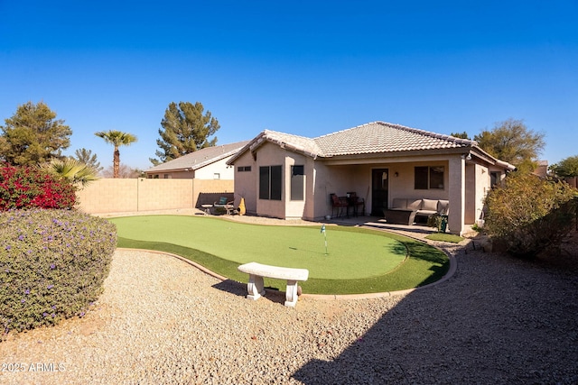 back of property featuring a patio area and outdoor lounge area