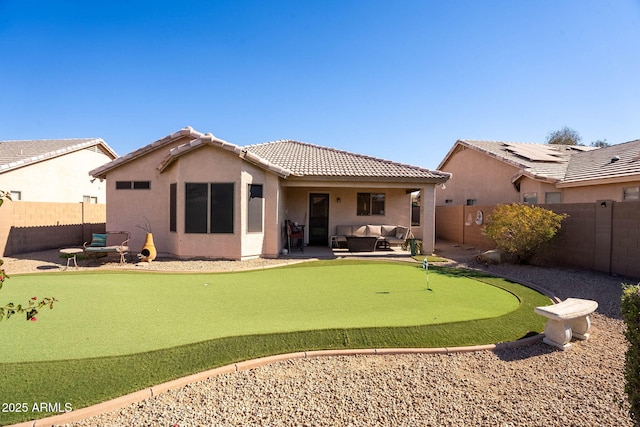 rear view of property featuring outdoor lounge area and a patio area