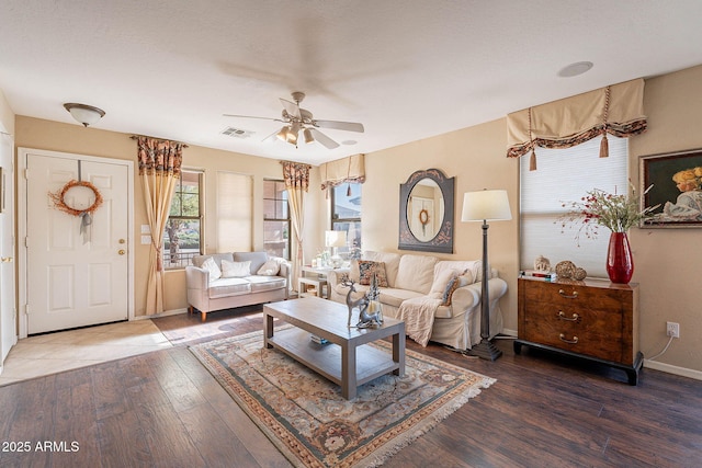 living room featuring ceiling fan, dark wood-type flooring, and a textured ceiling