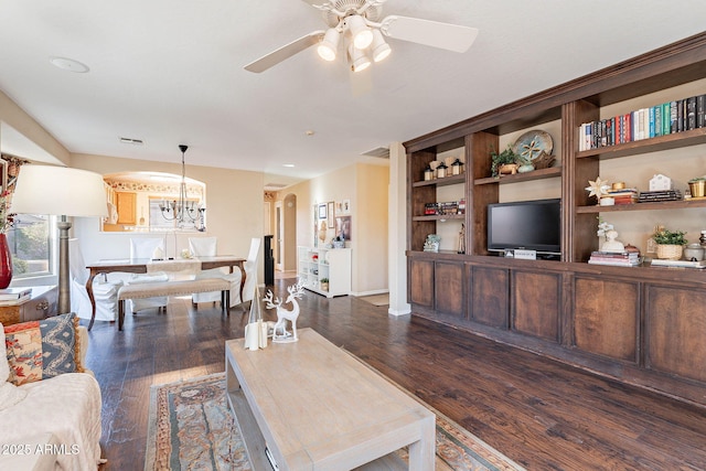 living room featuring ceiling fan with notable chandelier and dark hardwood / wood-style flooring