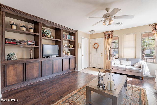 living room featuring dark hardwood / wood-style floors and ceiling fan