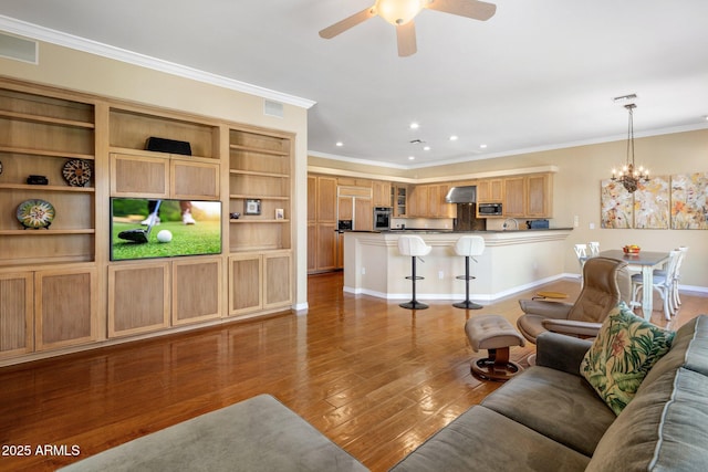 living room featuring ornamental molding, dark wood-type flooring, and ceiling fan with notable chandelier