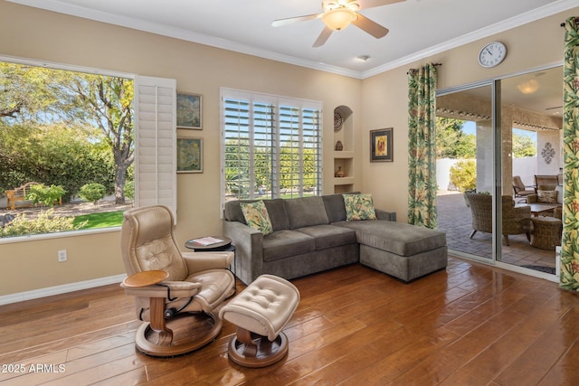 living room with ornamental molding, a healthy amount of sunlight, and hardwood / wood-style floors