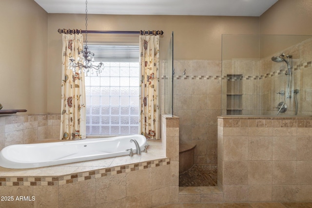 bathroom featuring shower with separate bathtub