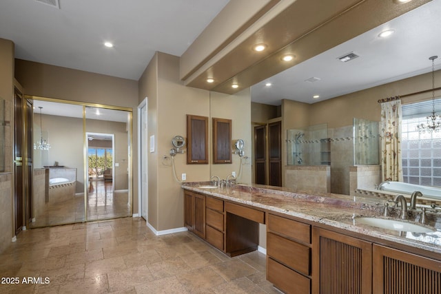 bathroom featuring shower with separate bathtub, vanity, and an inviting chandelier