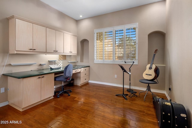 office area featuring dark wood-type flooring and built in desk