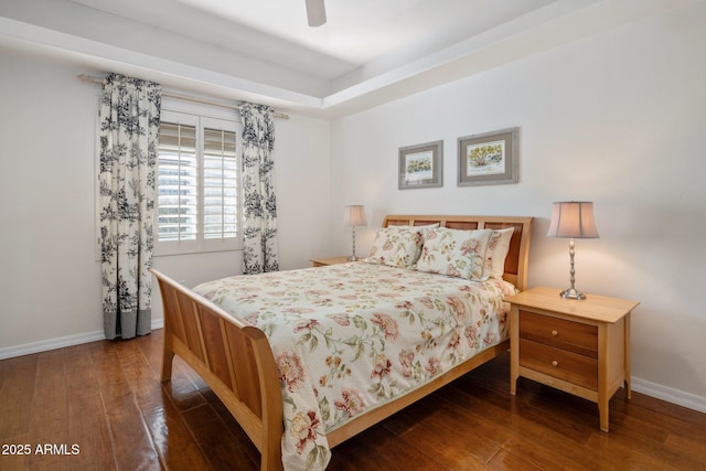 bedroom with dark hardwood / wood-style flooring and ceiling fan