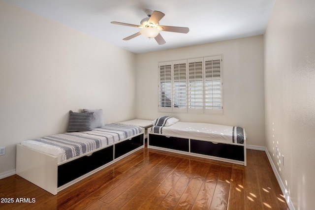 bedroom with dark wood-type flooring and ceiling fan