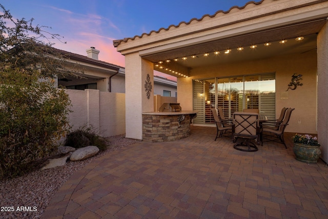 patio terrace at dusk with area for grilling