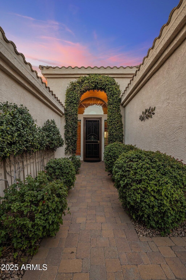 view of exterior entry at dusk