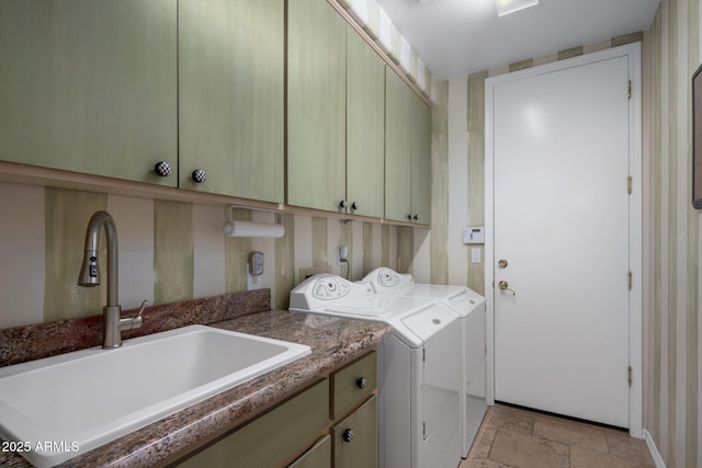 washroom featuring cabinets, sink, and washer and clothes dryer