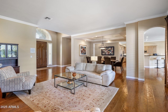 living room featuring ornamental molding and dark hardwood / wood-style floors