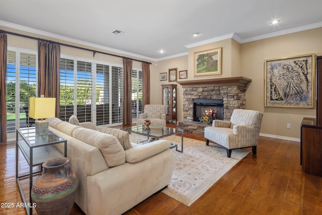 living room featuring hardwood / wood-style flooring, crown molding, and a fireplace