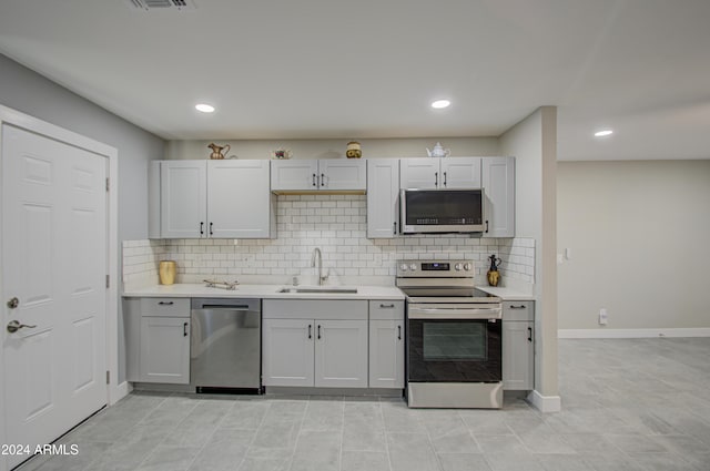 kitchen featuring sink, backsplash, and appliances with stainless steel finishes