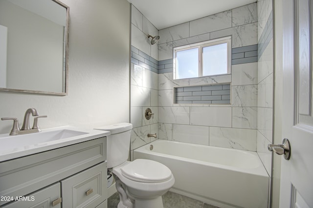 full bathroom with toilet, tiled shower / bath, and vanity