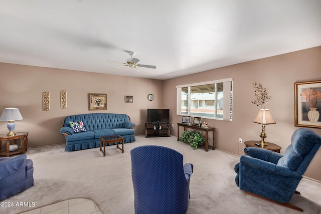 carpeted living room with ceiling fan