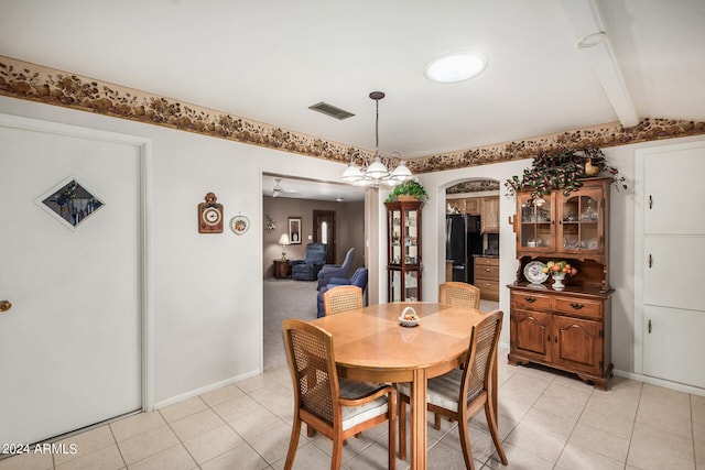 tiled dining area featuring vaulted ceiling with beams and ceiling fan with notable chandelier