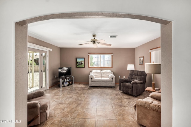 tiled living room featuring ceiling fan