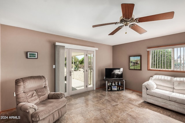 living room featuring a healthy amount of sunlight, ceiling fan, and light tile floors