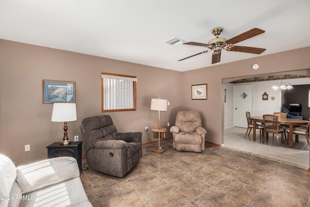 tiled living room featuring ceiling fan